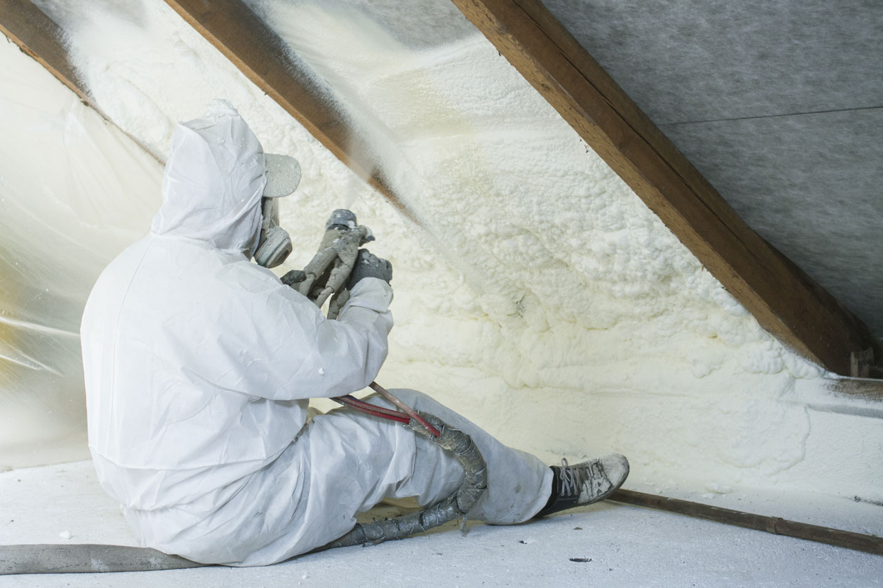 A professional performing Spray Foam Insulation for weatherization